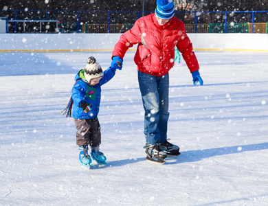 父亲和小儿子学习滑冰