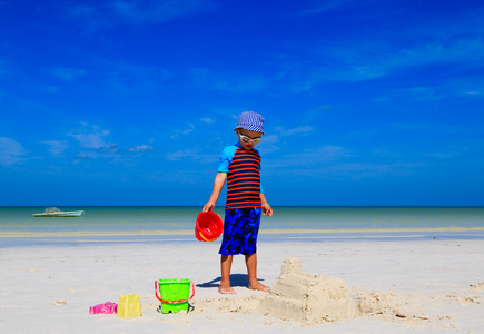 儿童建设热带海滩上的堆沙堡