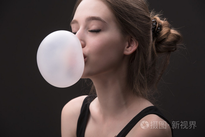 嚼口香糖的泡沫性棕色头发的女孩