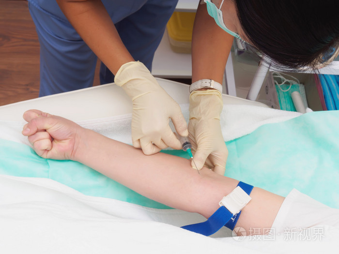 医生从女性病人手臂抽血检查照片-正版商用图片1kbbrw-摄图新视界