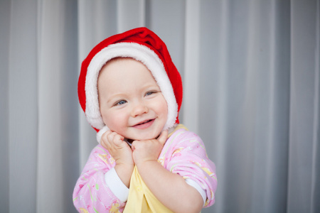 在红色的圣诞老人的帽子画像中的小女孩
