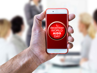 手机和世界艾滋病日红丝带与艾滋病的认识的概念