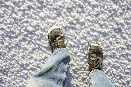 冷冻雪上的脏鞋和腿