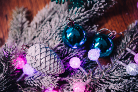 云杉分行在雪紫蓝色和白色圣诞球上深色木制背景