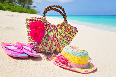 包 帽子 拖鞋和太阳镜上阳光明媚的沙滩，热带的 bea