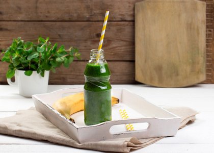 健康的绿色果汁，木制的桌子上