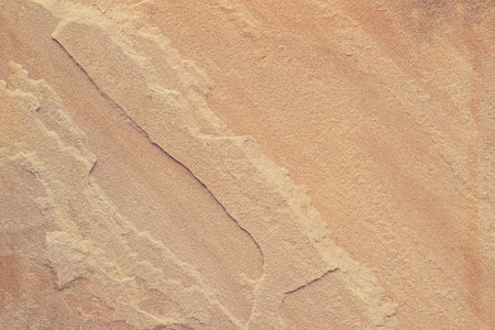 纹理褐色砂石为背景的