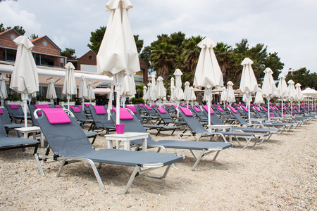 在沙滩上，海滩伞和塑料折叠椅希腊，pefk
