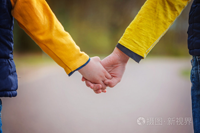 孩子们手牵着手在公园散步的时候的特写