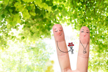 幸福夫妇的概念手指艺术。 男人正在送一束花。 股票形象