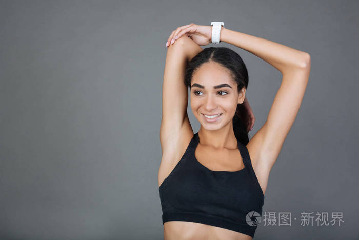 迷人的女孩抱着手臂肌肉在手肘弯曲