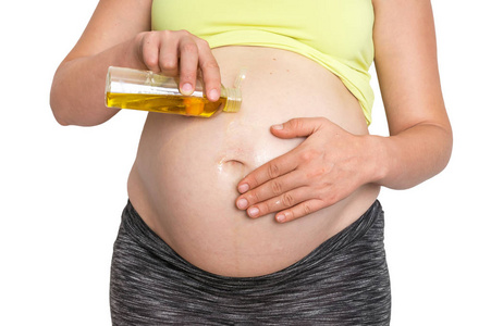 孕妇在腹部涂润肤油图片