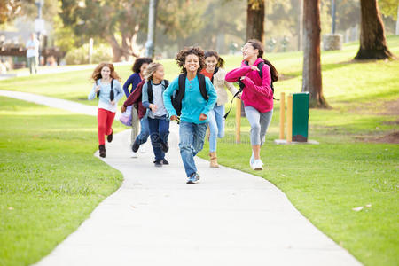 一群孩子在公园沿着通往相机的跑