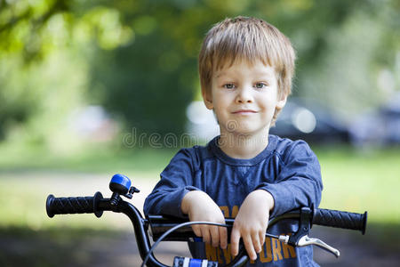 男孩在城市公园骑自行车