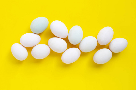 White eggs on yellow background. 