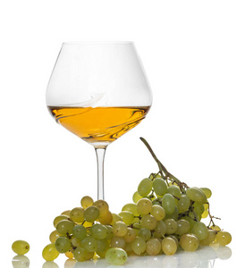 glass of white wine with a bunch of grapes 