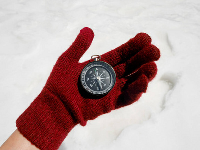 Travelers hand holding compass 