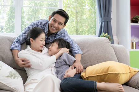 亚裔家庭的父亲，母亲和儿子在一起微笑生活