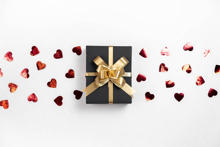 情人节背景。白底红心纸屑手工礼品盒。简约风格和情人节概念。平面布置，俯视图，复制空间