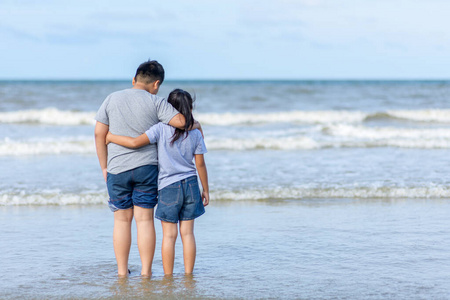 Two kids walking on beach, travel on vacation 