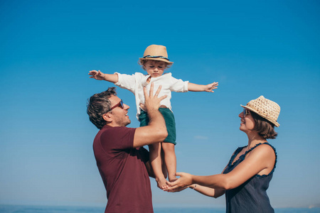 Portrait of a happy family with a little son on a trip near the 