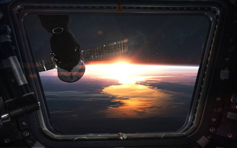 Look at the sunrise from space station window. Elements of this 