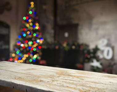 Empty table in front of christmas tree with decorations backgrou