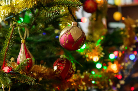 Christmas tree branch with baubles and lights. 