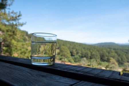 A glass of drinking water and Mountain View background 
