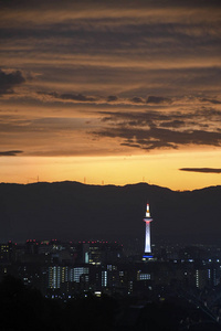 Colorful Kyoto Tower at night with Kyoto city skyline 