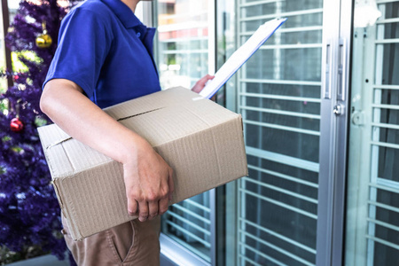 Delivery man deliver box parcel package and clipboard documents 