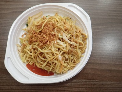  chinese noodles fire with vegetables on a plastic plate