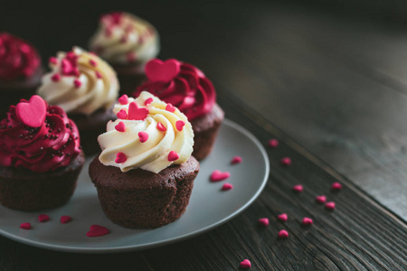 Valentine cupcakes in white and red colors, served on the plate 