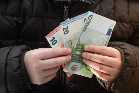 Hands holding cash euro banknotes currencies. 