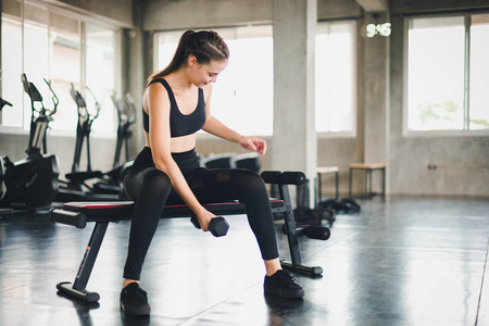 Beautiful girl caucasian is exercising with lifting dumbbell in 