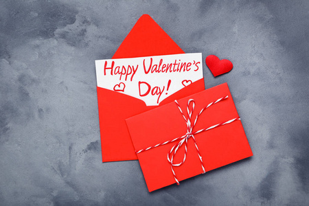 Paper envelope with heart and text Happy Valentines Day on grey 