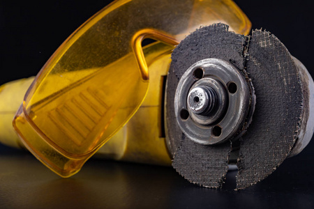 Damaged cutting disc for metal in an angle grinder. Power tools 