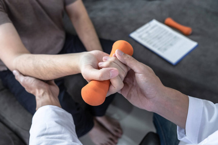 Doctor physiotherapist treating arm pain patient doing physical 