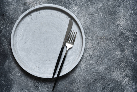 Table setting. Empty plate, knife, fork and napkin. Top view 