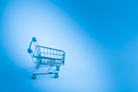 Empty trolley shopping cart on light background.