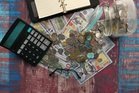 top view of coin, cash and calculator 