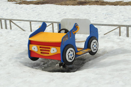 Childrens swing in the form of a car on the playground 