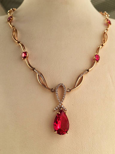  Gold ruby necklace on a jewelry stand. luxury jewelry.