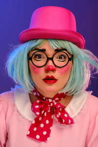 Closeup portrait of a clown girl with blue hair in a pink hat, 