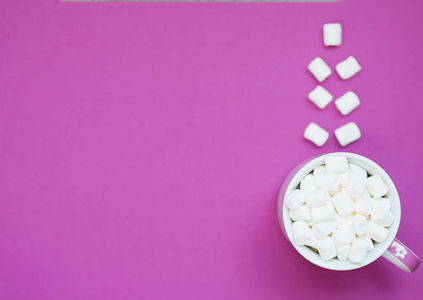 Cup of cocoa with marshmallows on a purple background 