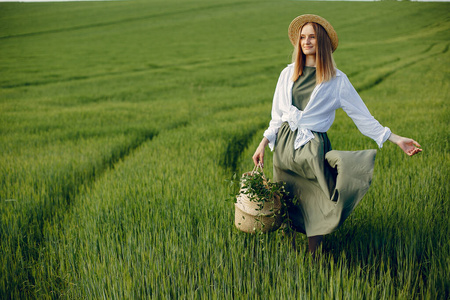 Elegant and stylish girl in a summer field