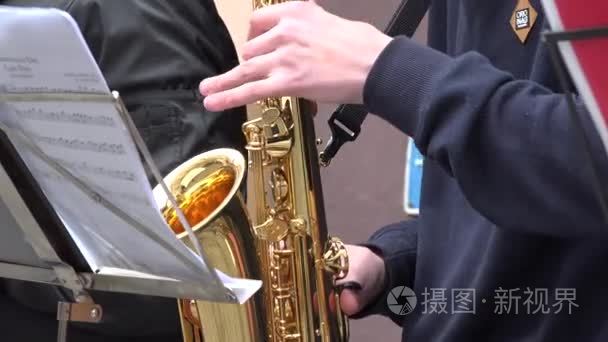 boys troop play wind instruments saxophones. 4K