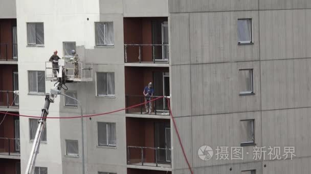 workers paint new modern flat house wall with roller. 4K