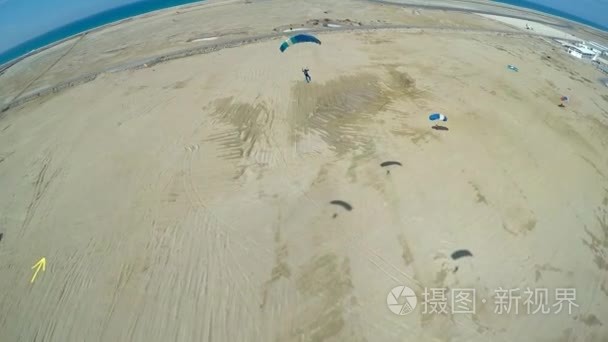 Skydiver is landing on parachute