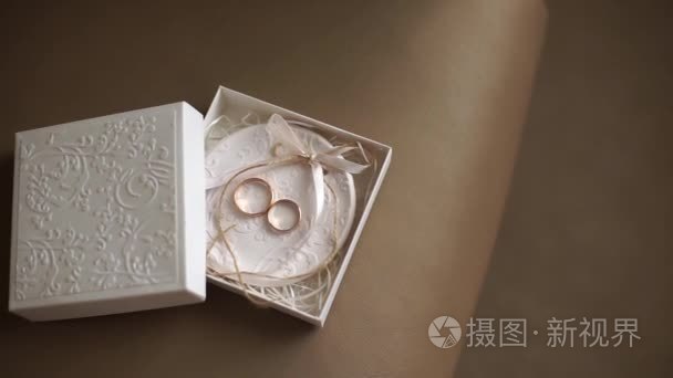 两个结婚戒指在可爱白色的小盒子